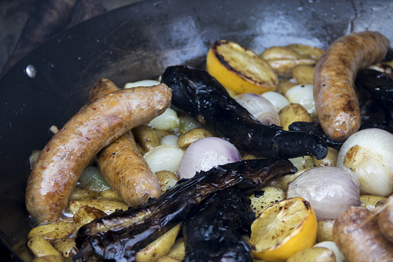 Onions, sausage, lemon and more in a frying pan